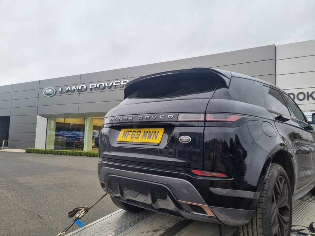 Professional car recovery service in action — a tow truck safely loading a broken-down vehicle on the roadside. Reliable roadside assistance available 24/7 for accidents, breakdowns, and vehicle transport. Fast, safe, and affordable car recovery solutions.